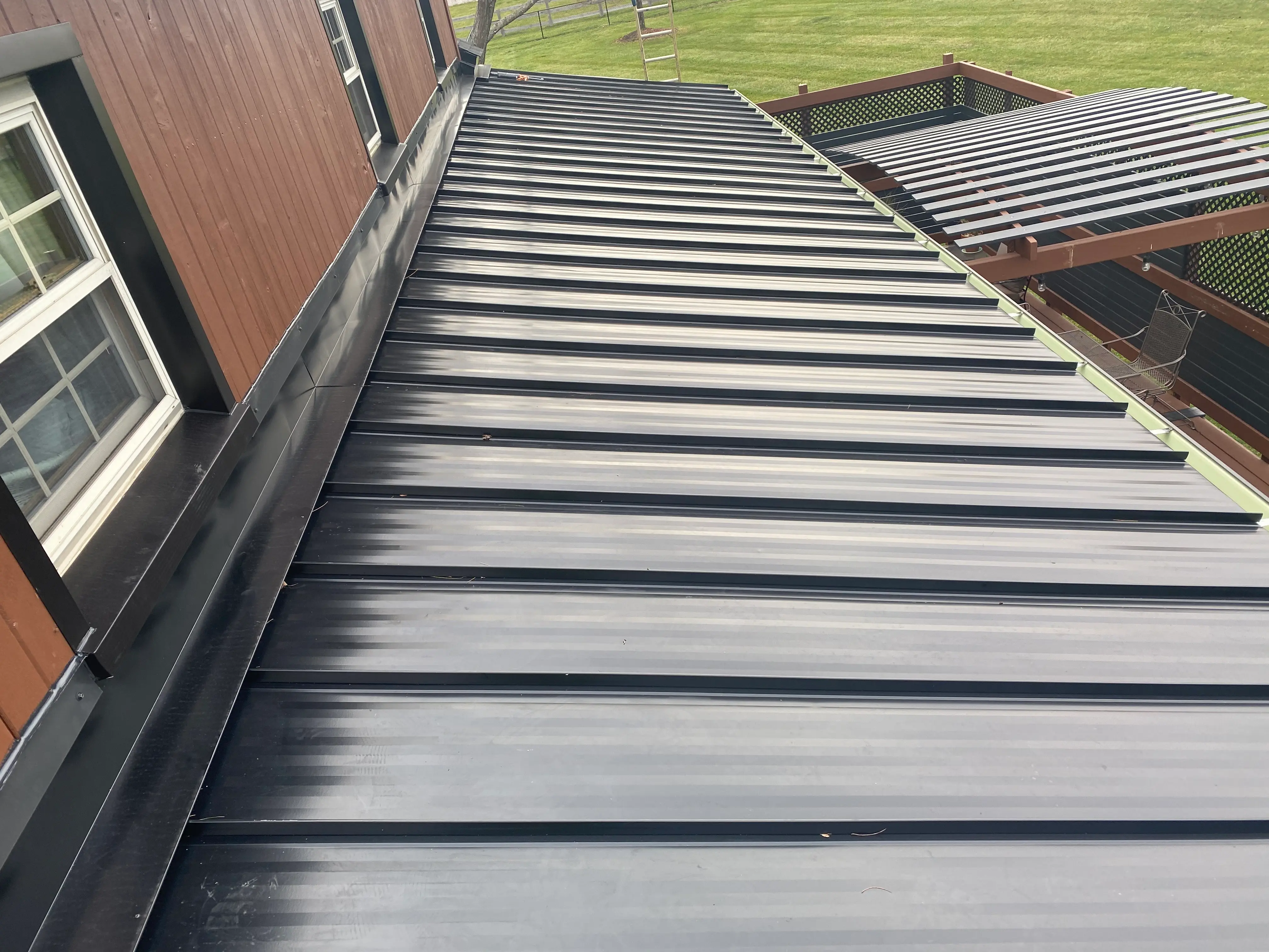 Sleek black metal roof panels installed